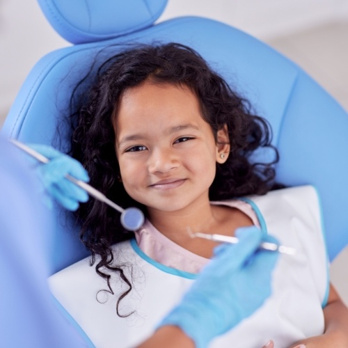 Young girl grimacing in dental chair