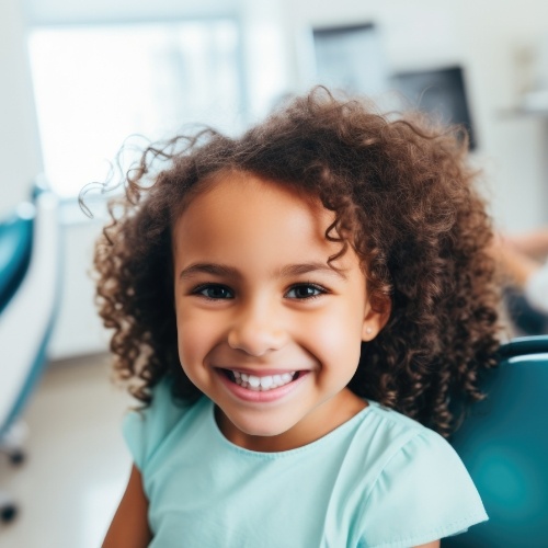 Young girl grinning in dental chair