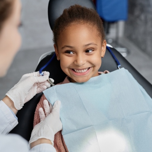 Young girl grinning at her dentist