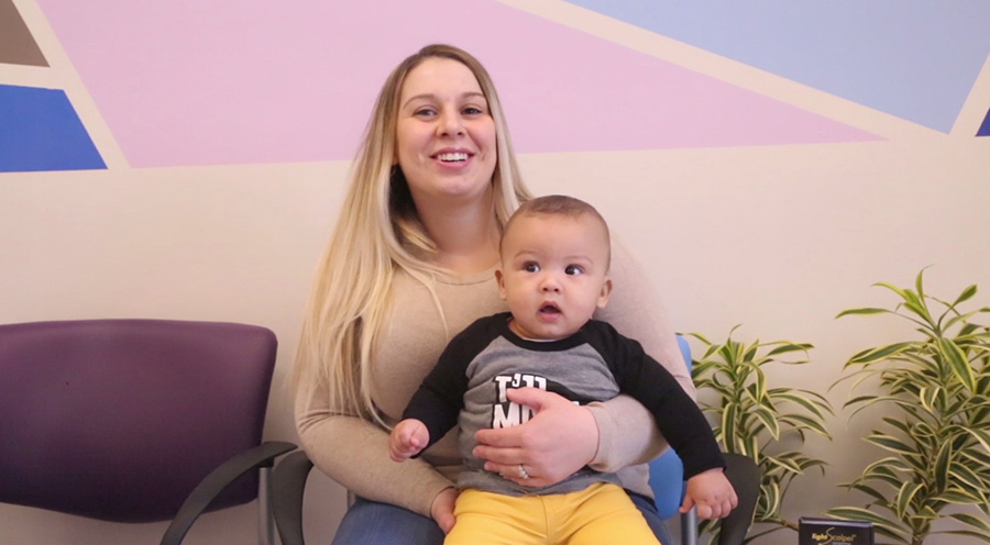 Woman sitting with her baby on her lap in Southampton pediatric dental office