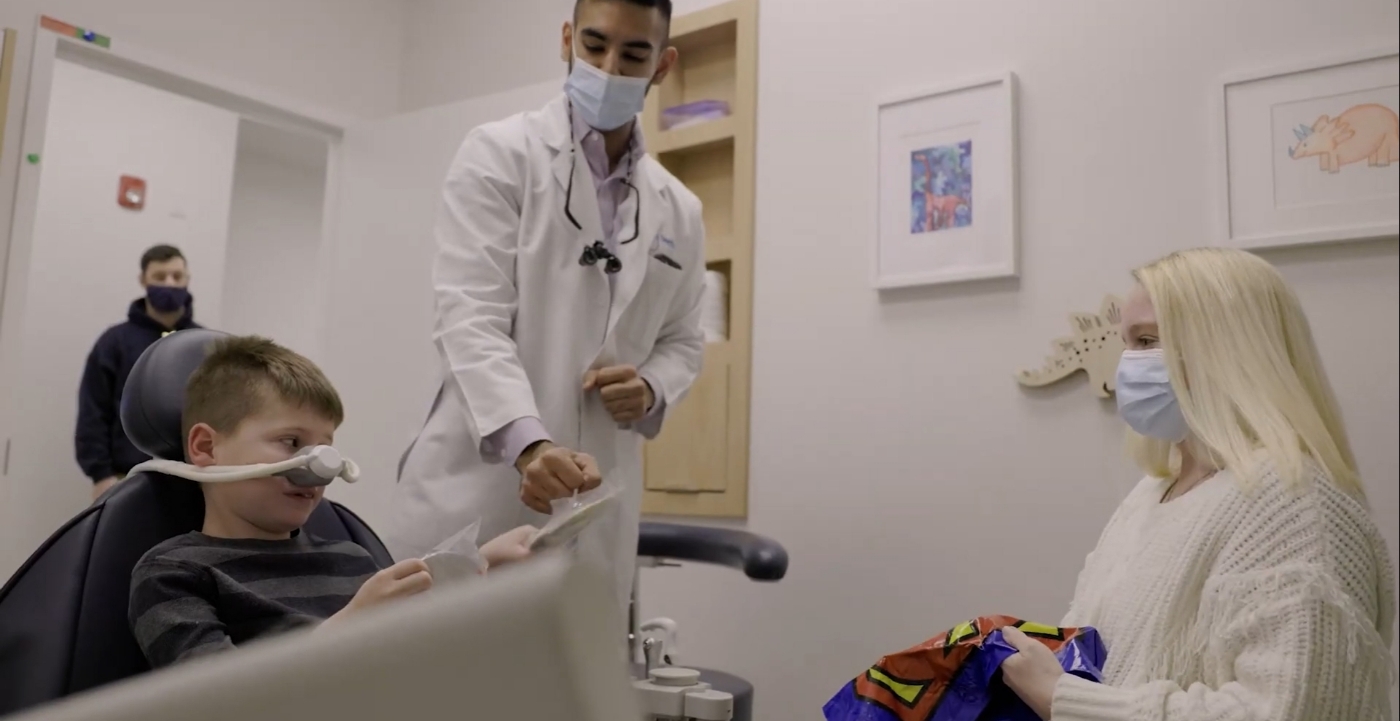 Southampton pediatric dentist talking with a young boy in the dental chair