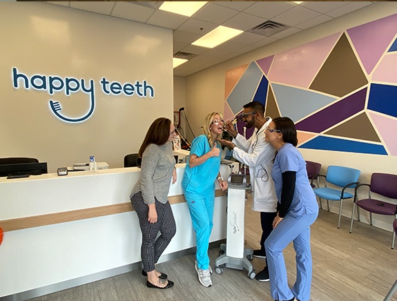 Happy Teeth of Southampton dental team and dentist standing near front desk