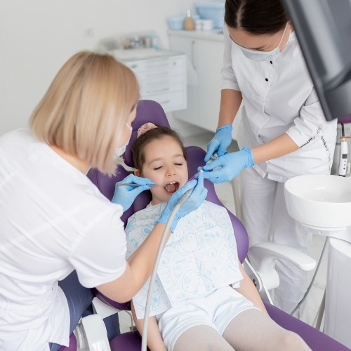 Young girl receiving dental treatment