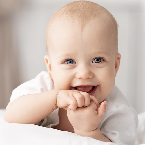 Laughing baby laying on their stomach