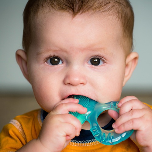 Toddler chewing on a teething ring