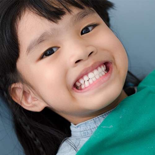 Young child grinning in dental chair